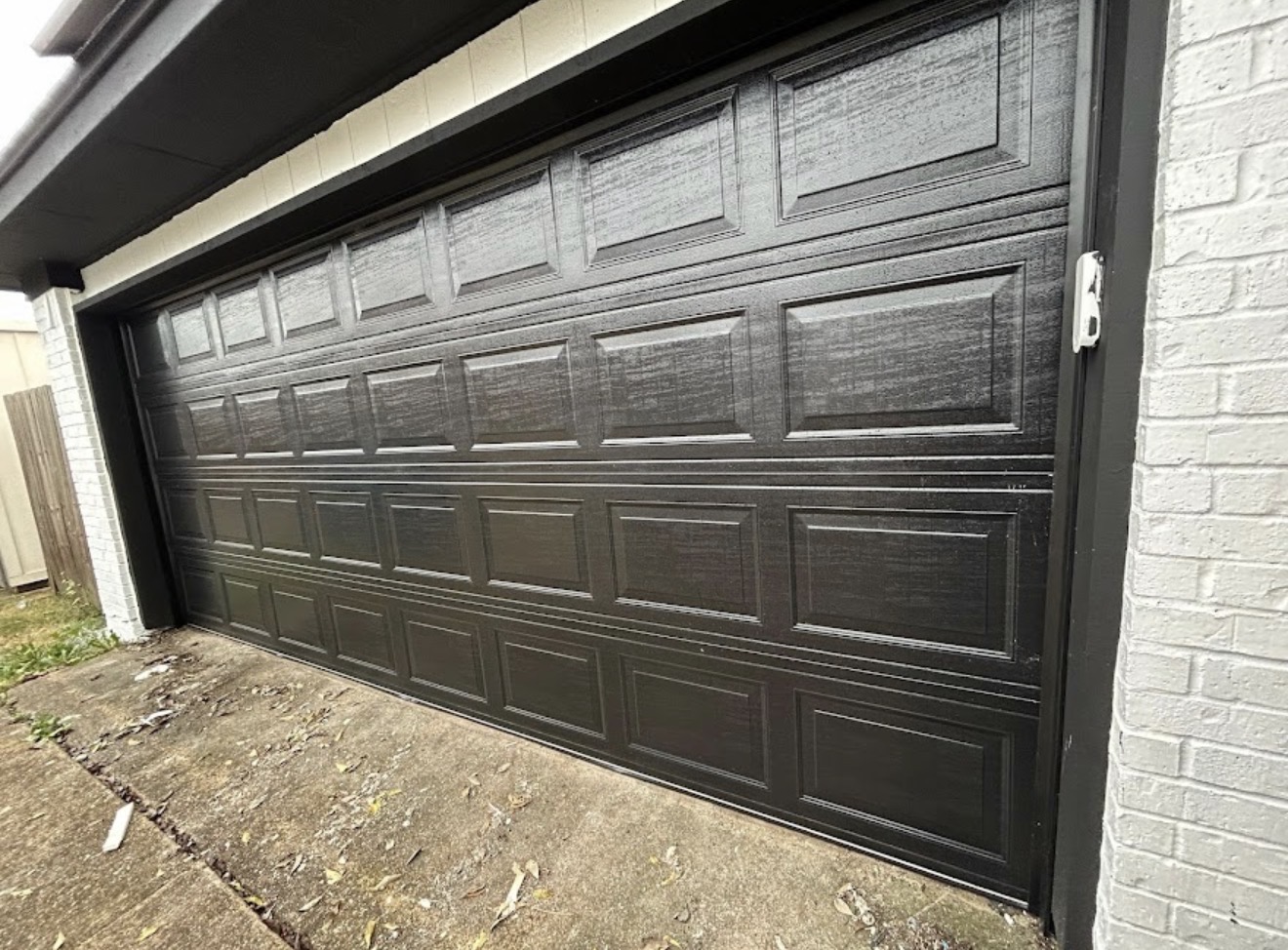 Technician repairing garage door spring DFW TX